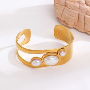Detailed view of 18k gold plated stainless steel cuff bracelet with faux pearl inlays