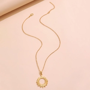 Detail of gold floral necklace with adjustable chain and round sunburst pendant