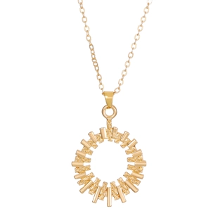 Macro shot of gold sunburst flower pendant with geometric rays and textured relief detail