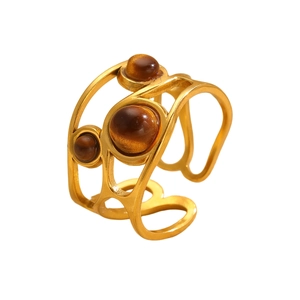Macro shot of 18k gold plated stainless steel ring with three tiger eye stones