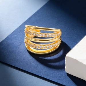 Luxe multi-layer gold-plated ear cuff with pavé zircon stones on navy background