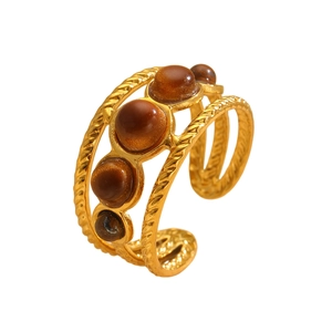 Detail of 18k gold plated open ring with tiger eye stones and twisted wire texture