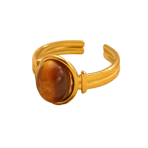 Close-up of 18k gold plated stainless steel ring with oval tiger eye stone in macro detail