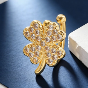 Detail of clover ear cuff with gold plating and sparkling cubic zirconia pavé setting