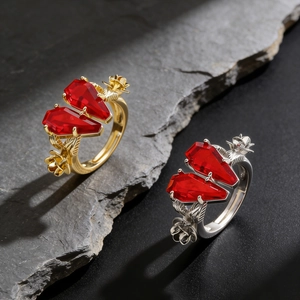 Detail of gothic rings with coffin-shaped rubies and rose engravings on stone