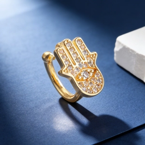 Detail of gold Hamsa hand ear cuff with Evil Eye and micro-pave cubic zirconia crystals