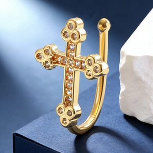 Macro shot of gold-plated cross ear cuff with micro-set sparkling zircon stones