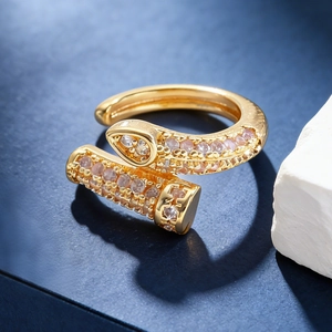 Close-up of golden nail-shaped cuff earring with sparkling zircon pavé setting