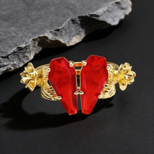 Gothic gold ring featuring red coffin stones forming a heart with rose flower carvings