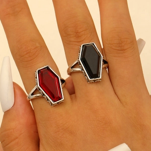 Detail of gothic silver rings with scarlet and black coffin-shaped gemstones and beaded edges