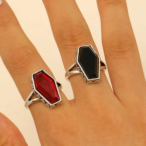 Detailed close-up of gothic coffin rings with red ruby and black onyx style stones