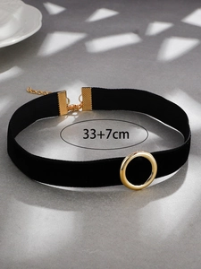 Detail view of black velvet choker with gold metal ring and 33+7cm adjustable chain