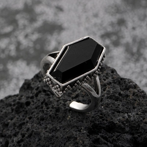 Detailed macro view of Gothic ring with black coffin stone and silver rose pattern