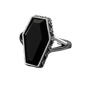 Detail view of gothic coffin ring with black stone and rose engraving on silver band