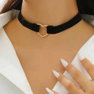 Close-up of black velvet choker featuring a golden heart-shaped metal buckle detail