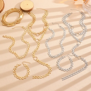 Detailed view of layered gold and silver chain necklaces with round ring pendants