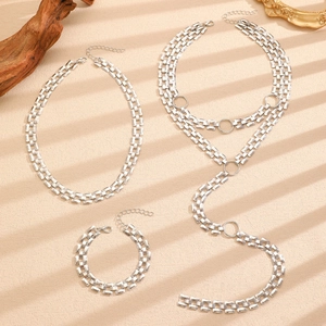 Detailed view of silver Y-shaped layered necklaces and matching bracelet set