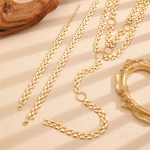 Detail of multi-layer golden link chain necklace with square pattern and lobster clasp