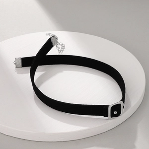 Detail of black velvet choker featuring a silver square buckle and adjustable metal chain