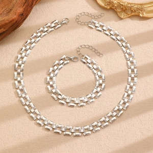 Detailed view of silver chunky link necklace and bracelet set with lobster clasp closure