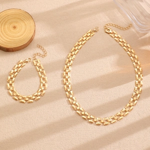 Detail of gold-plated rectangular link chain necklace and bracelet set with lobster clasp