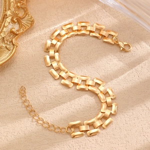 Detail of matte gold rectangular link bracelet with lobster clasp and extender chain