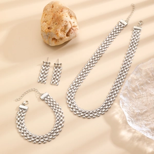 Detailed close-up of polished silver layered bead chain necklace and bracelet set