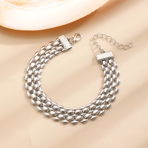 Detailed macro view of triple-row silver link bracelet with lobster clasp and extension