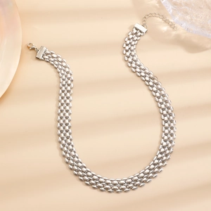 Detailed view of silver triple-strand metal bead necklace with lobster clasp and extension