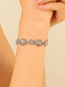 Close-up of vintage hollow rose link bracelet in silver finish worn on female wrist