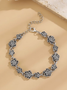 Detailed close-up of retro silver rose flower bracelet with adjustable clasp and links