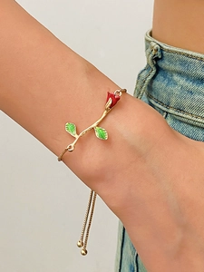 Detail of vintage rose bracelet with red enamel bud and adjustable gold chain