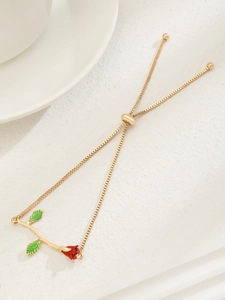 Detail of vintage rose bracelet with red enamel bud, green leaves and adjustable slide clasp