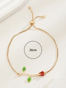 Detailed close-up of 26cm golden rose bracelet with red petals and green leaves