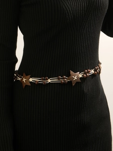 Detail of woven cotton rope belt with wooden star and beads on a black dress