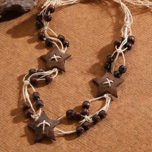 Close-up of bohemian woven rope belt featuring wooden beads and handcrafted stars