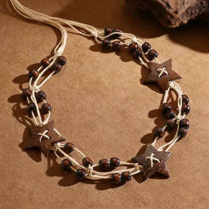 Bohemian braided waist chain with ethnic star-shaped wooden beads on brown surface