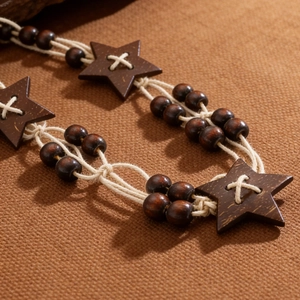 Macro view of bohemian braided waist chain featuring wooden beads and star coconut shell detail
