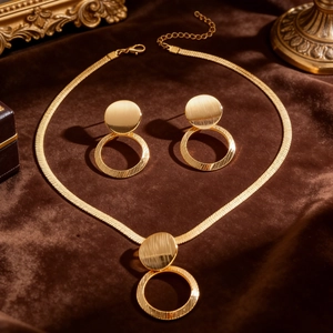 Elegant gold geometric circle jewelry set with necklace and stud earrings on velvet