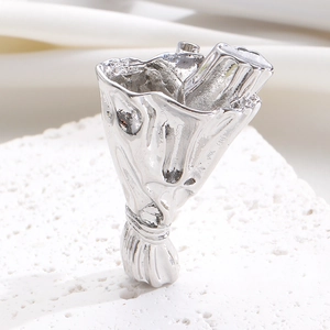 Artistic silver flower bouquet ring with textured metal petals on white display