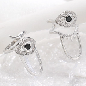 Macro shot of silver evil eye nail ring set with cubic zirconia on crystal background