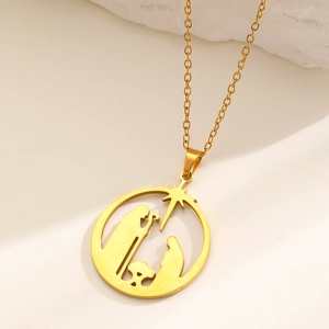 Gold stainless steel religious nativity scene pendant necklace on stone background