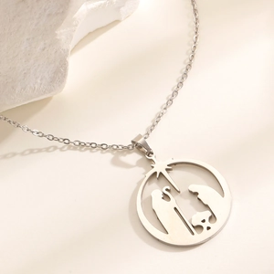 Detailed close-up of polished silver religious nativity scene on hollow circle pendant