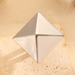 Macro detail of high-shine silver geometric pyramid metal element for bold statement rings