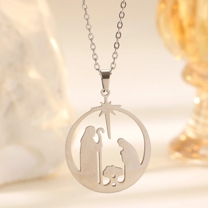 Detailed close-up of a silver stainless steel hollow Nativity scene pendant and thin chain