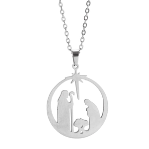 Macro detail of silver stainless steel circular pendant showing the Nativity cutout scene