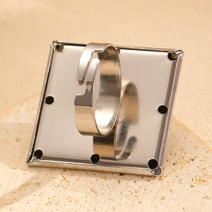 Close-up of adjustable silver square ring base with holes for DIY jewelry making