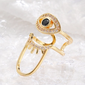 Macro shot of gold-plated Evil Eye nail ring with black zircon and micro-pave crystals