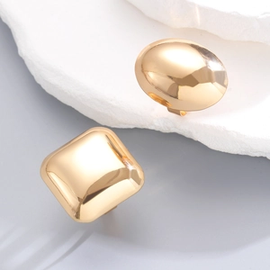 Detail of polished gold geometric square earrings with mirror finish and minimalist design