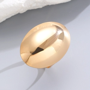 Detailed macro shot of a chunky gold oval geometric ring with a high polished finish